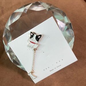Dog enamel pin with dangling bone